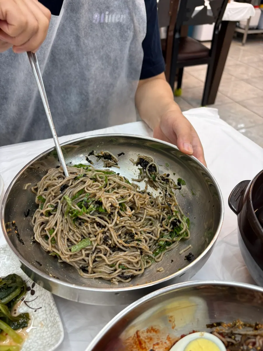 A bowl of perilla oil buckwheat noodles topped with perilla leaf