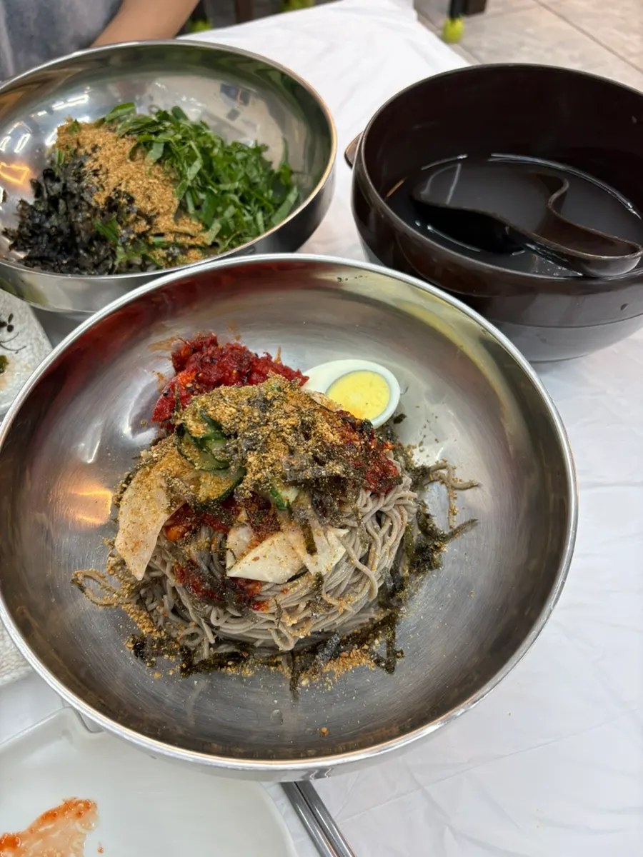 Sokcho pollack sashimi makguksu topped with pollack sashimi
