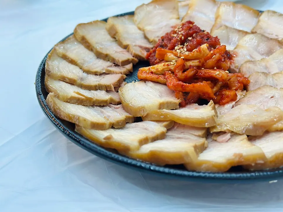 Suyuk plate with dried radish strips and seasoned pollack sashimi in the center