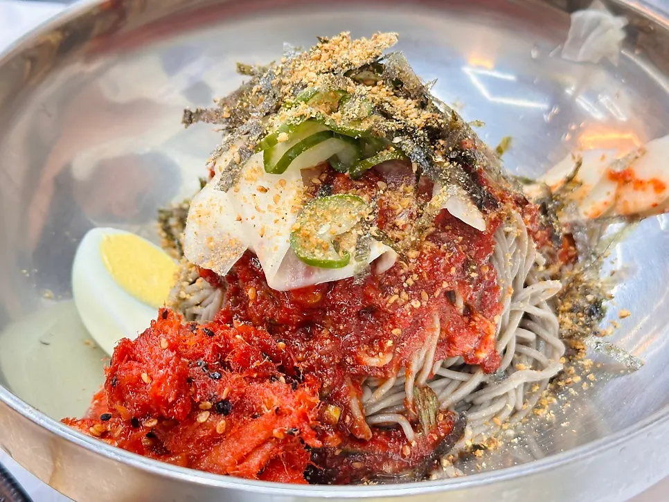 Close-up of buckwheat makguksu drizzled with perilla oil