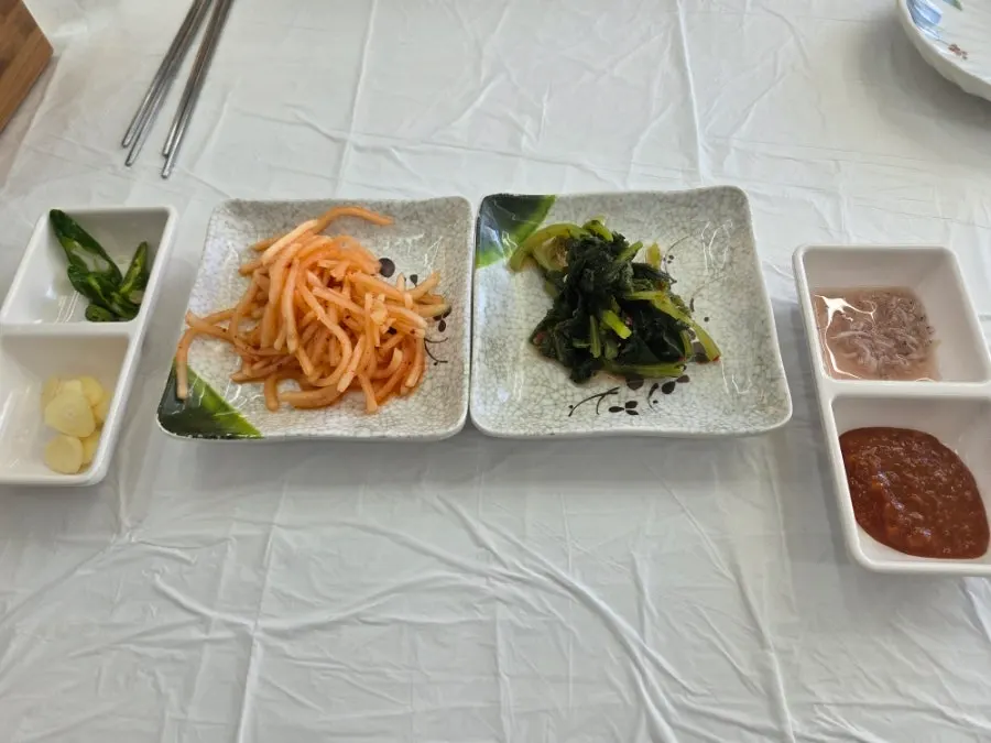 Basic side dishes including radish salad and yeolmu kimchi