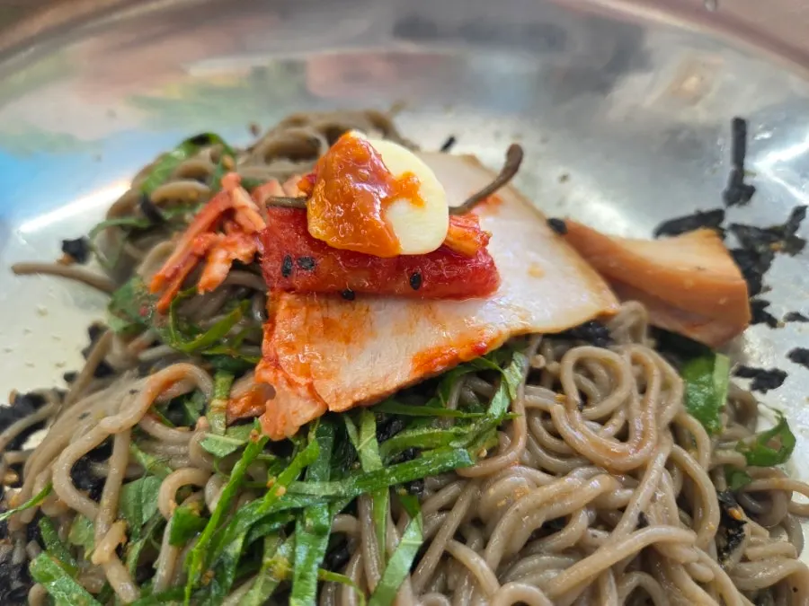 A table spread with suyuk and makguksu together
