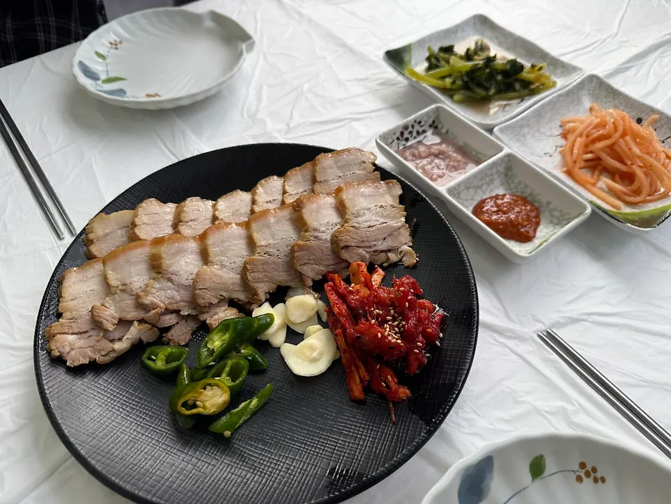 Solo boiled pork platter served with pollack salad and buckwheat makguksu