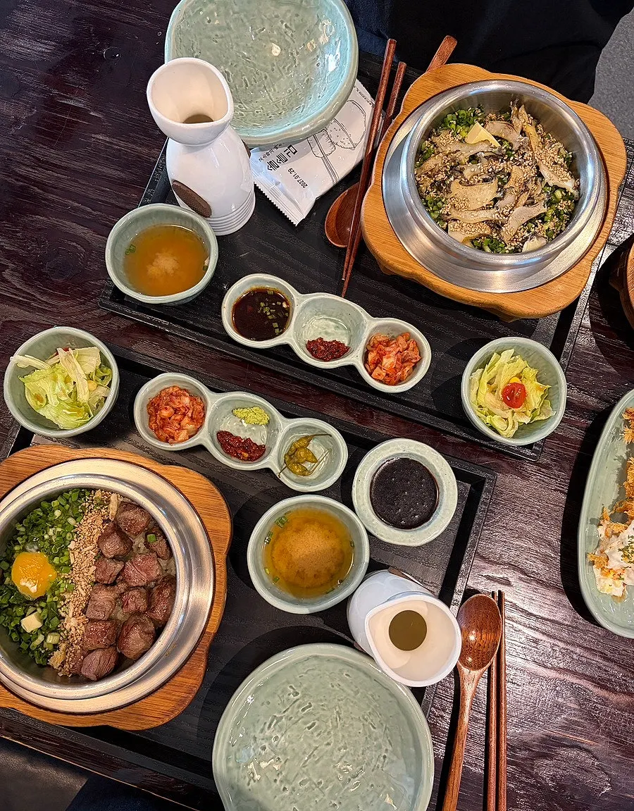 Table set with steak pot rice and abalone pot rice