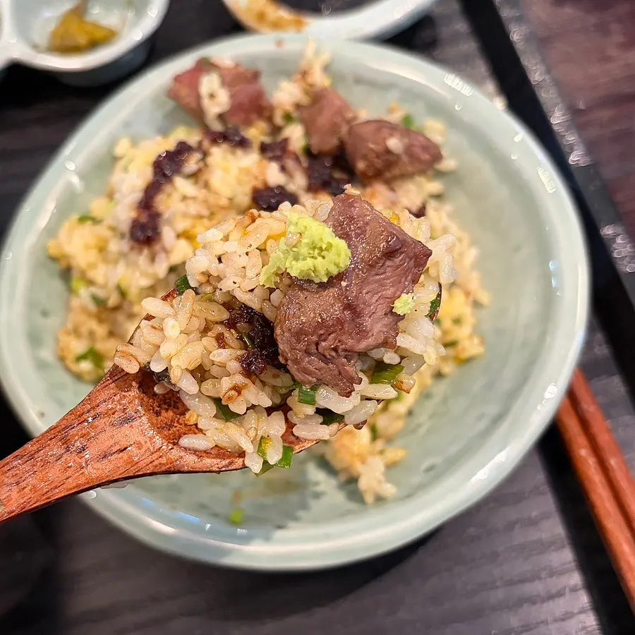 A bite of steak with the house special sauce