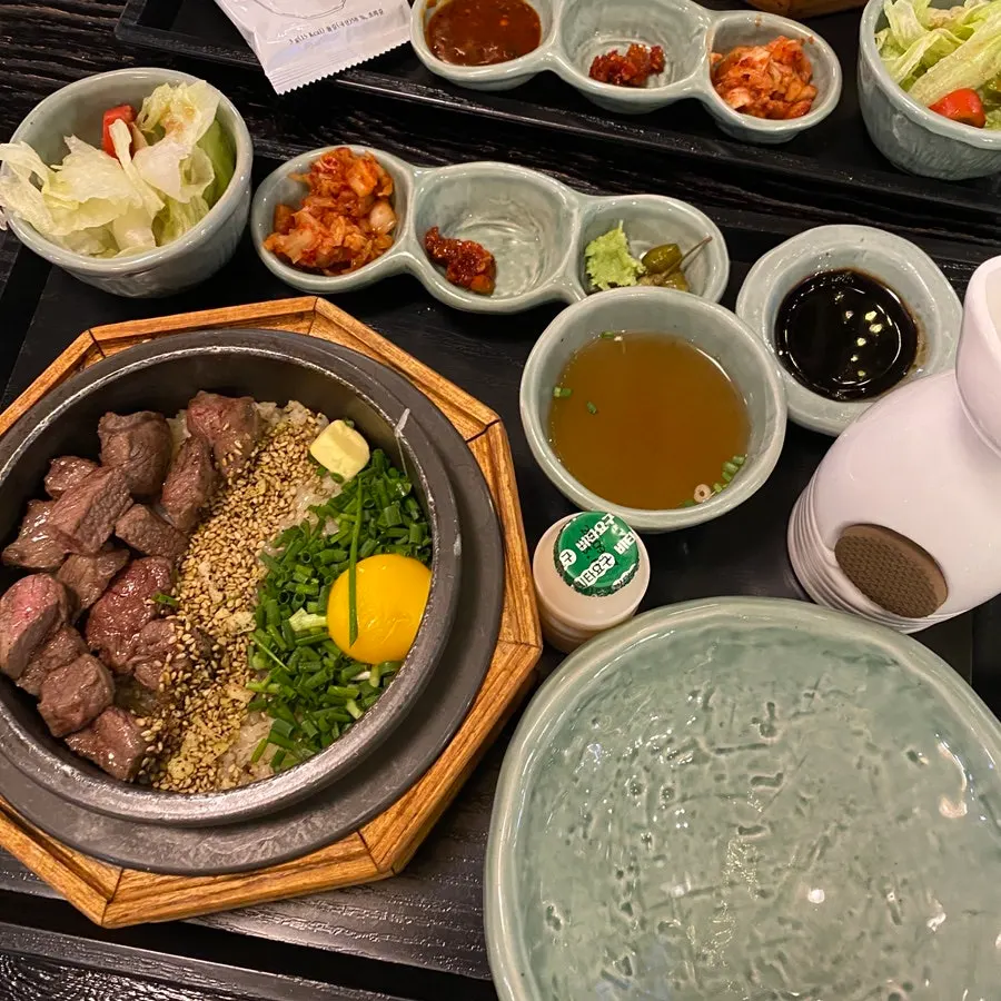 Steak pot rice served with a yogurt drink on the side