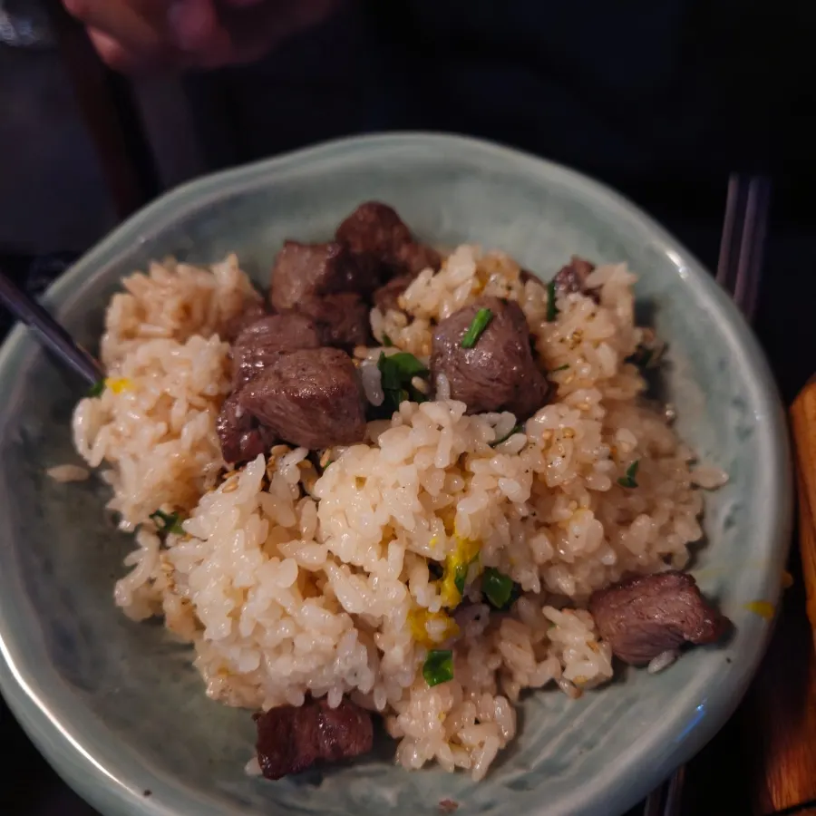 Steak pot rice topped with egg yolk