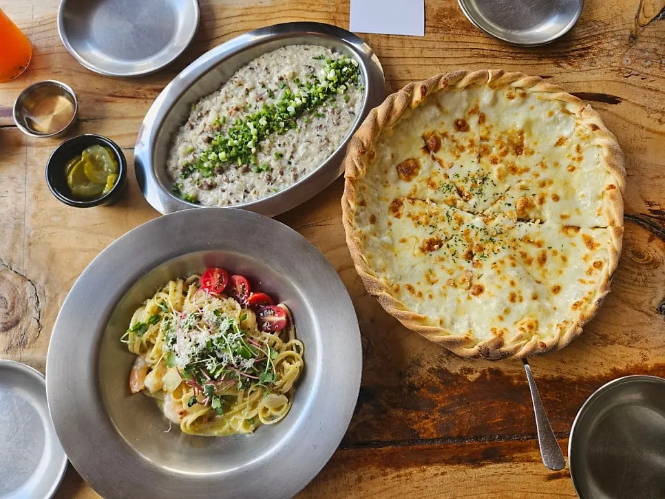 Table set with pizza, pasta, and risotto