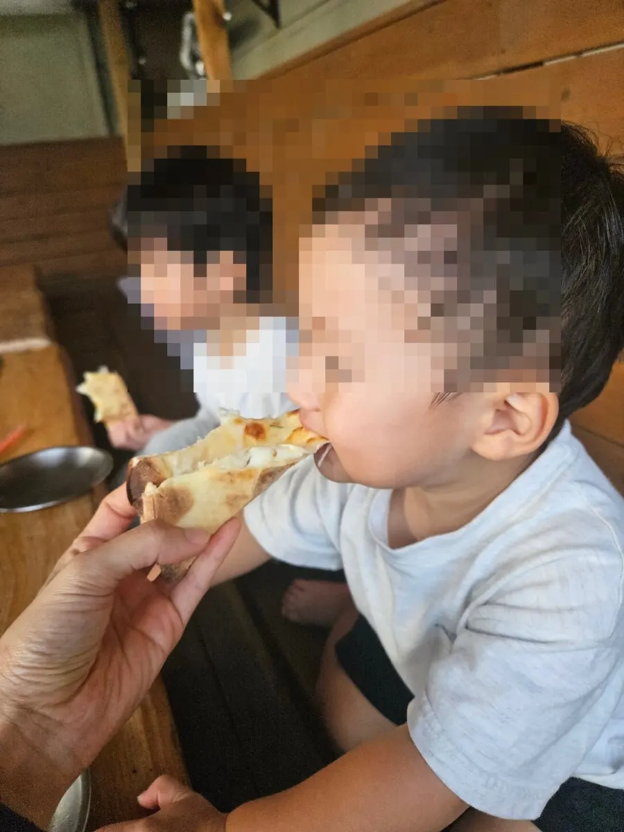 A slice of gorgonzola pizza dipped in honey