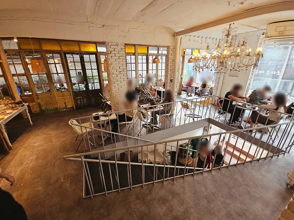 Floor-to-ceiling window seating atmosphere on the 2nd floor of Something About Coffee