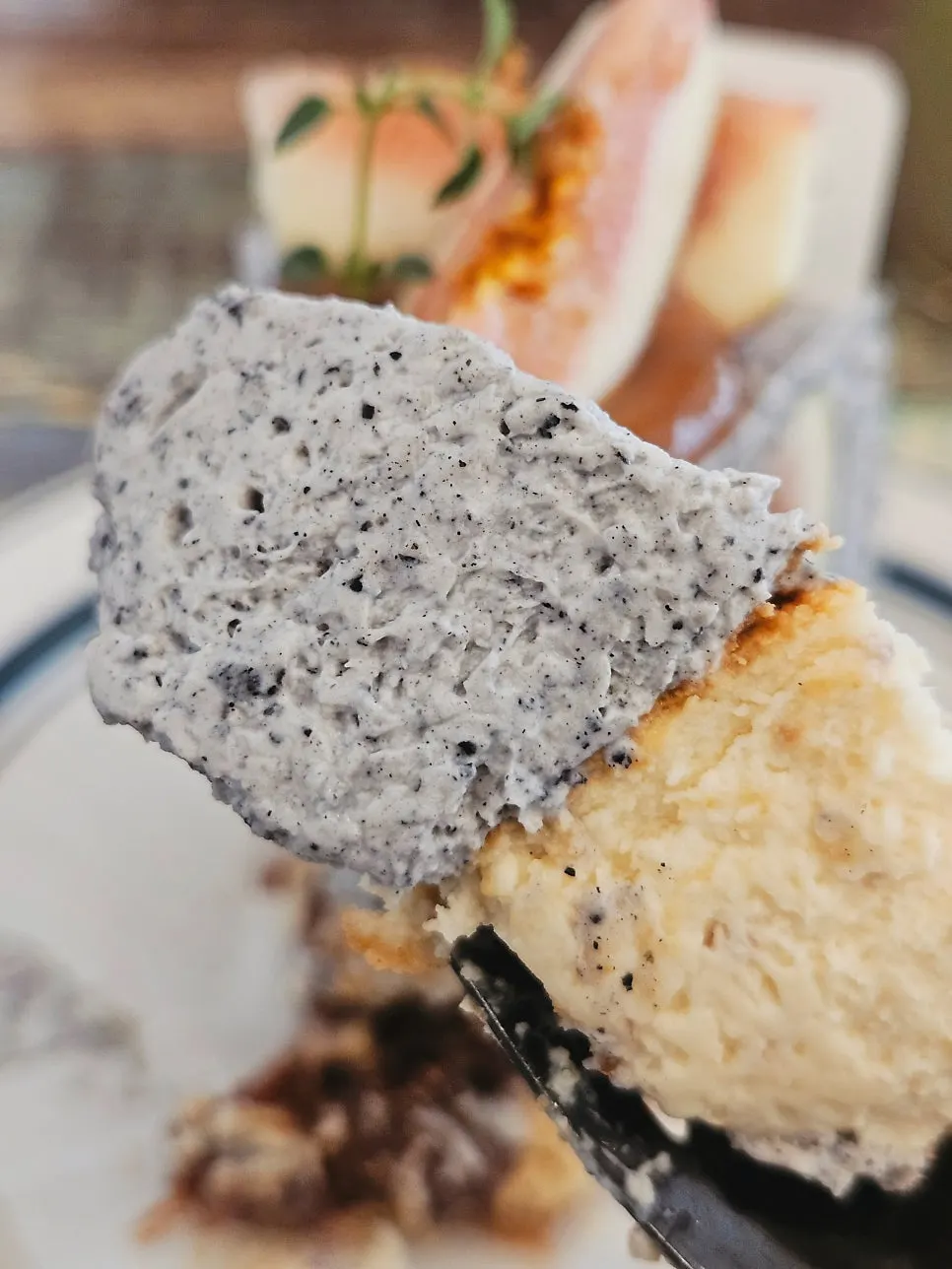 A slice of cheesecake with an Americano