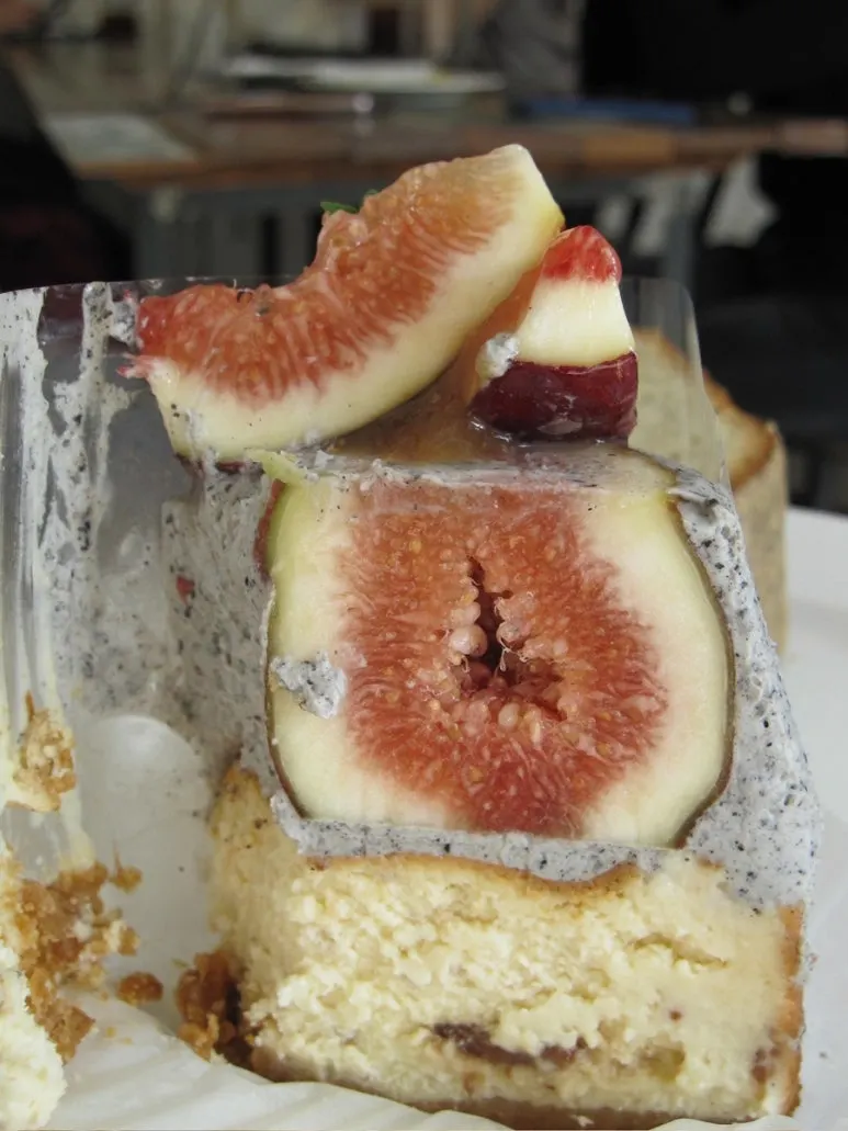 Cross-section of black sesame cake topped with fresh fig