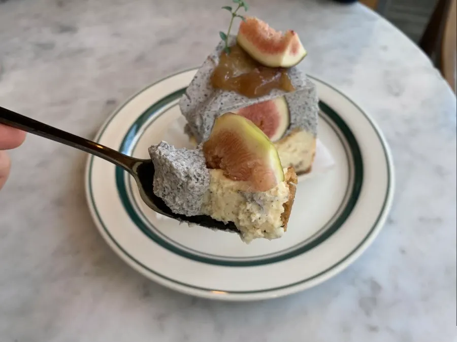 Cross-section of black sesame fig cheesecake scooped with a large fork