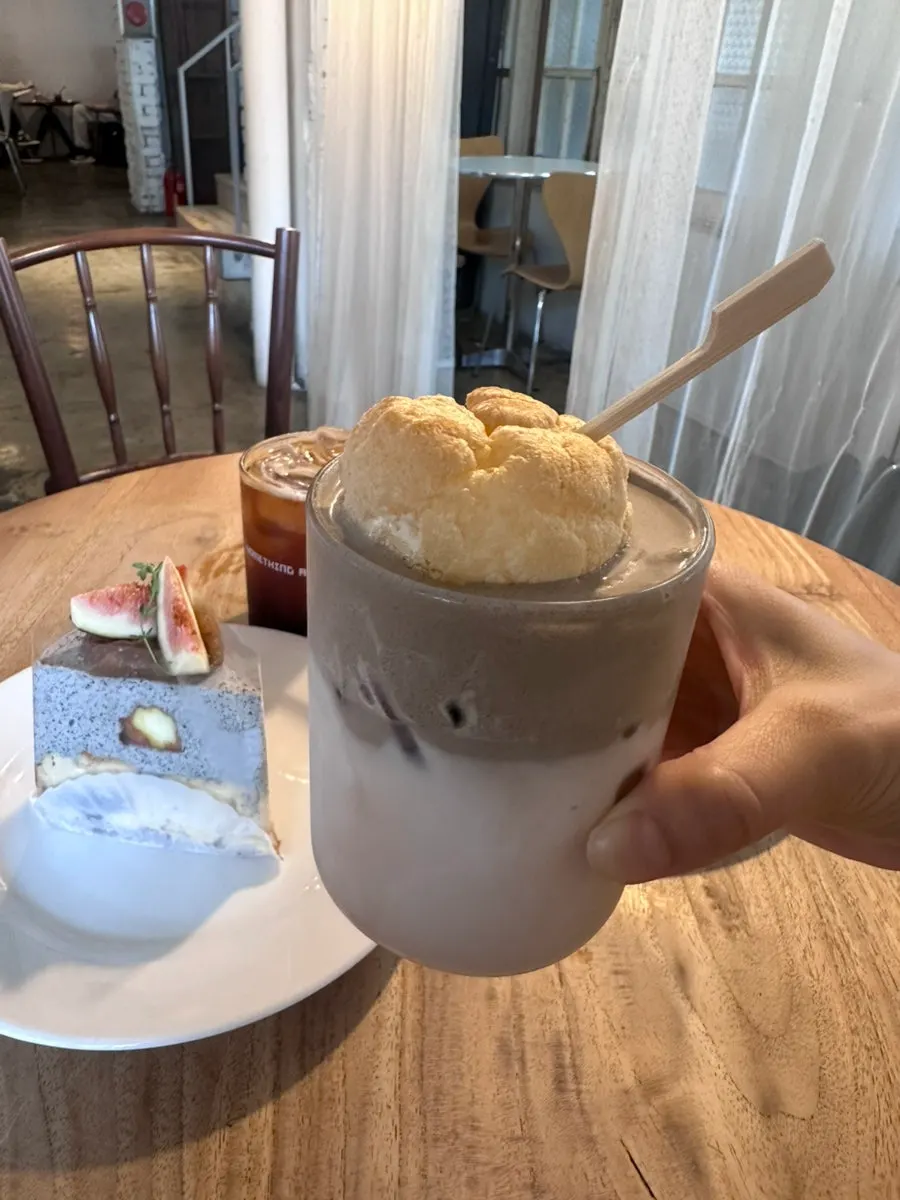 Table set with hojicha choux milk tea and two slices of cake
