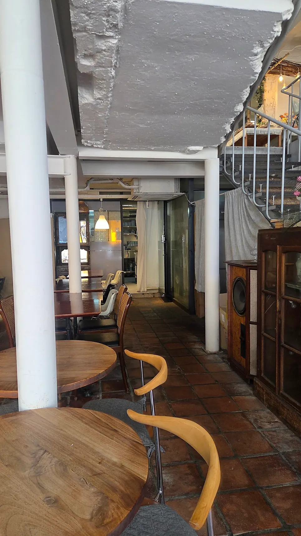 Wood-toned interior with street trees reflected in a mirror