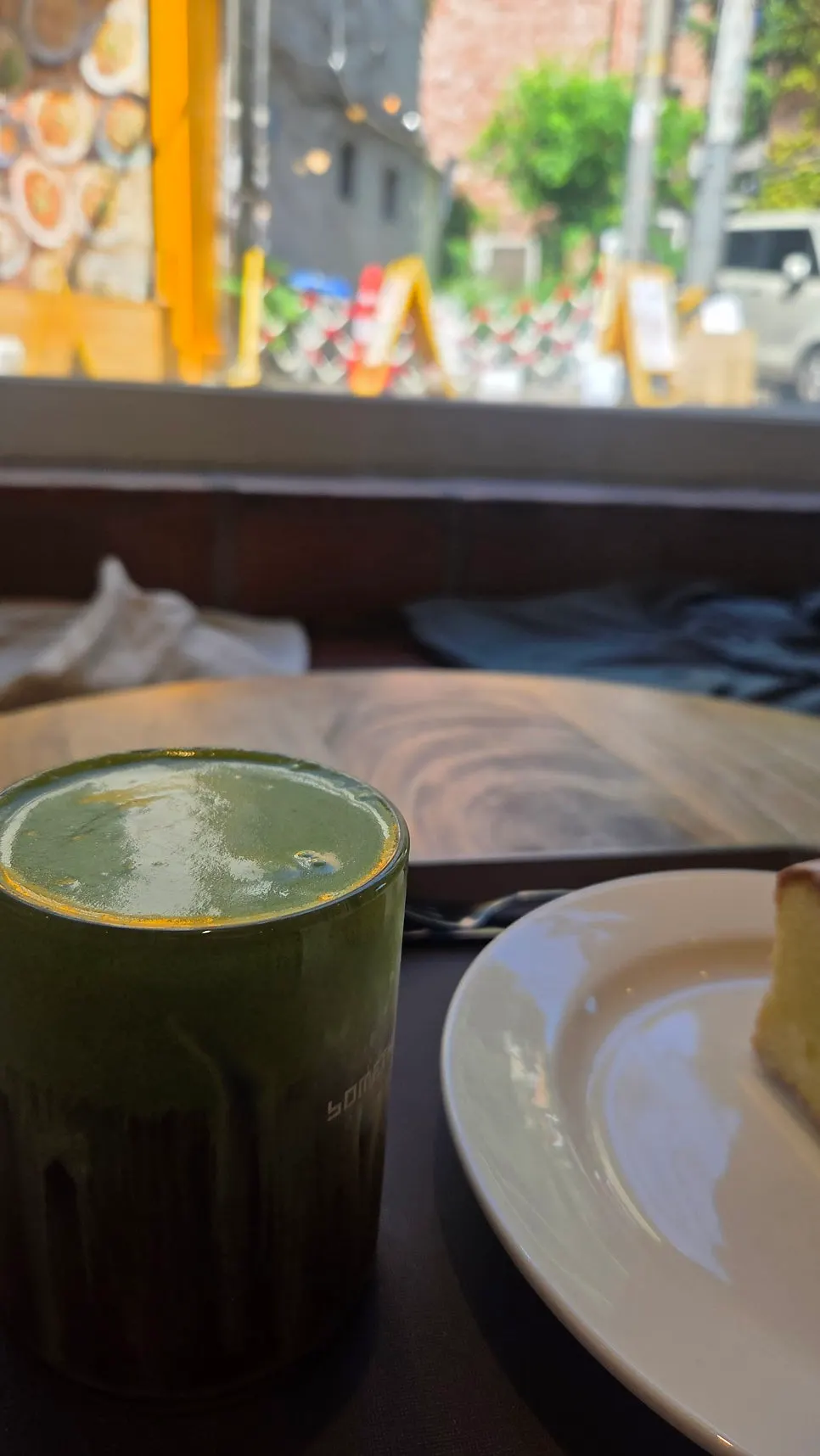 Drink and dessert set on a window-side table