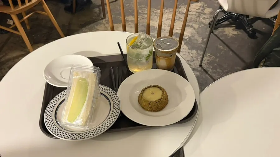 Four drinks and desserts set out on the table