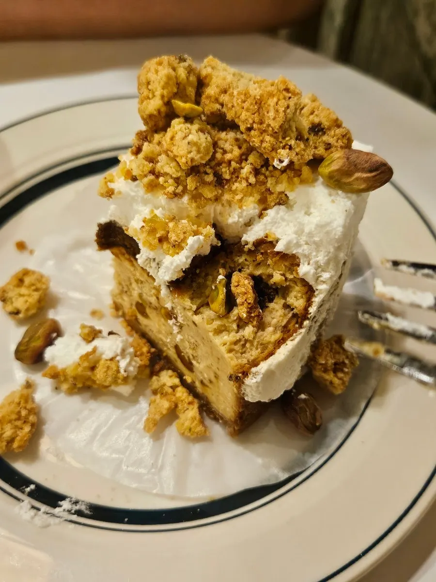 Cross-section of cheesecake with pistachio bits inside