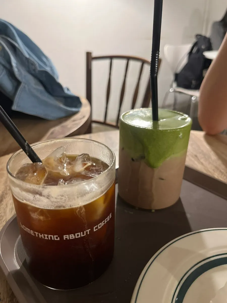 Iced Americano next to the matcha cream choco latte