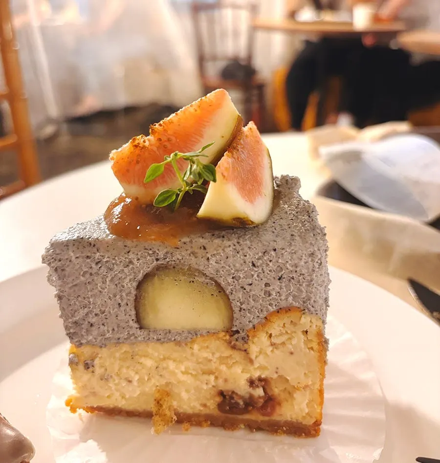 Cross-section of the cake showing black sesame cream and cheese