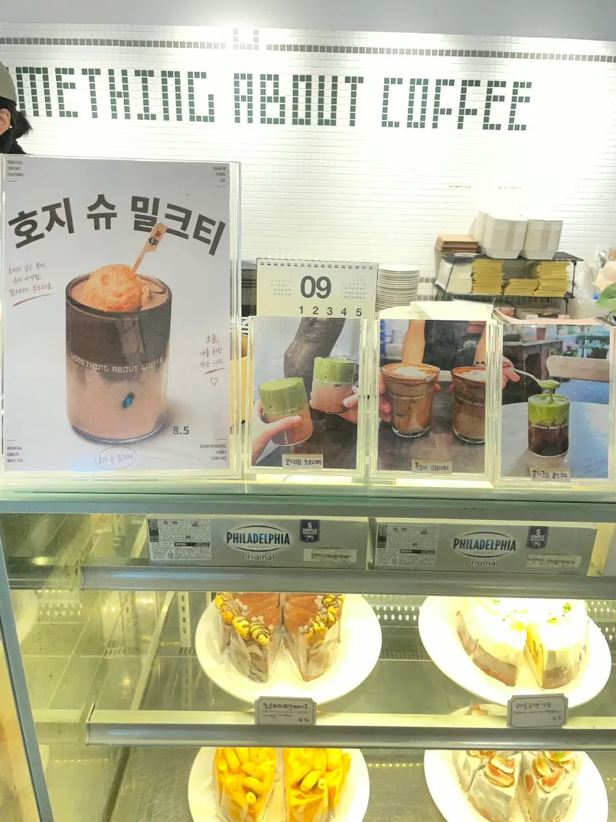 Drink menu board listing coffee and non-coffee items at Something About Coffee