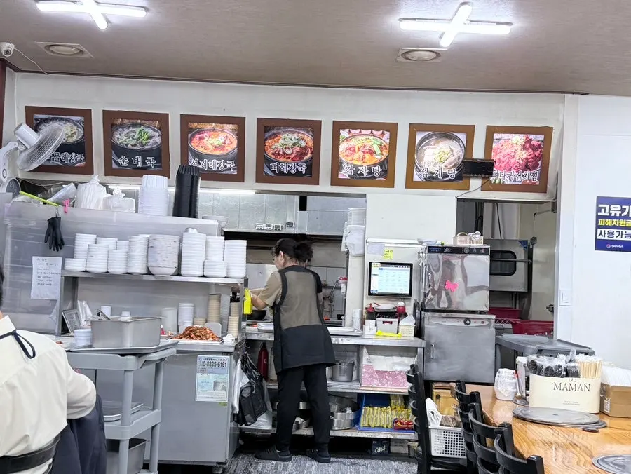 Interior seating and aisle of the gamjatang restaurant