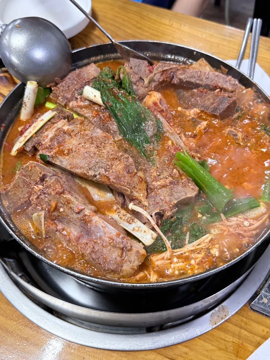 Gamjatang and bone-in meat starting to boil