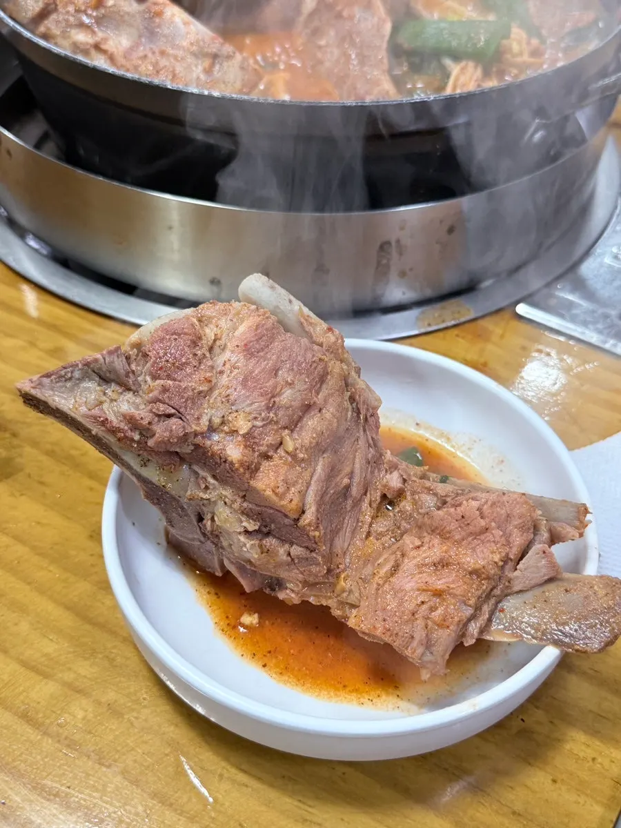 Tender bone-in meat pulled apart with chopsticks