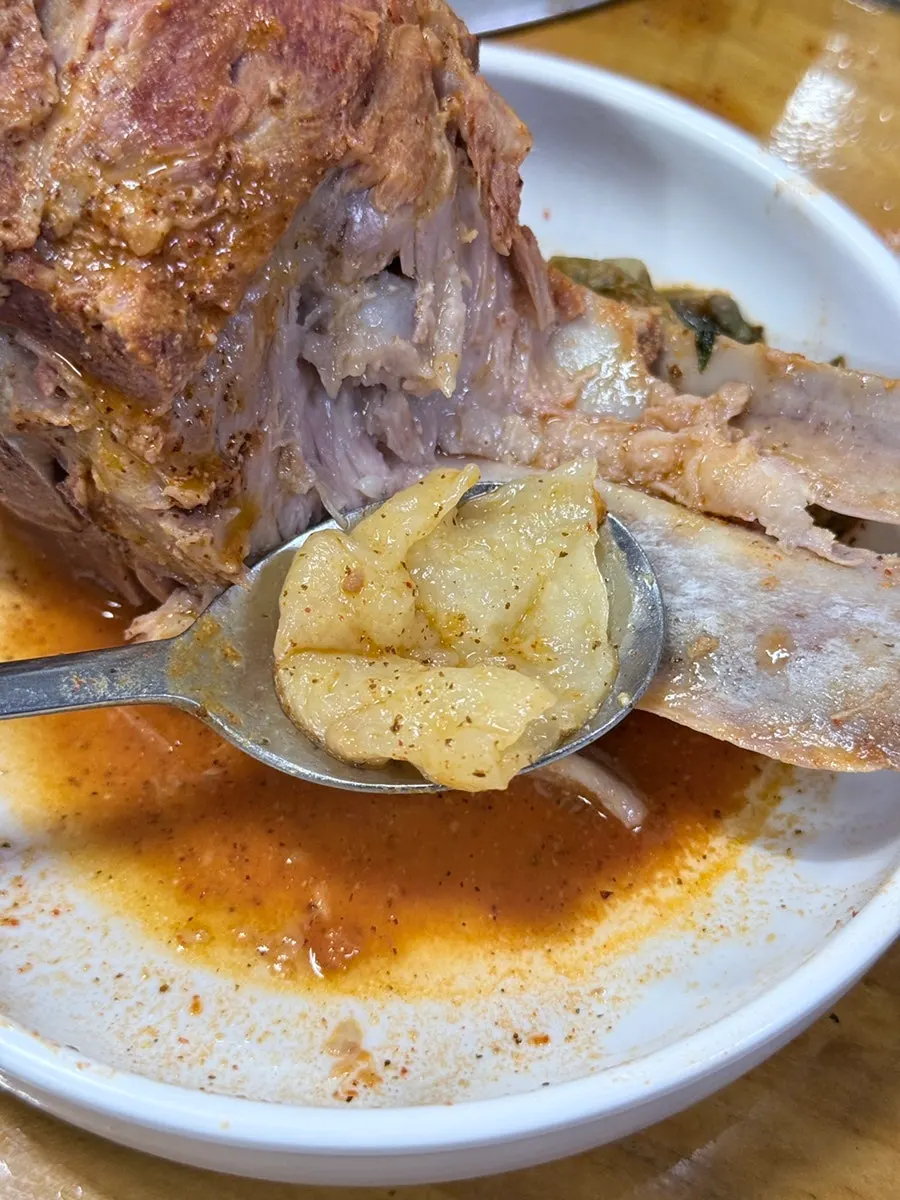 Hand-torn sujebi dough being added to the pot