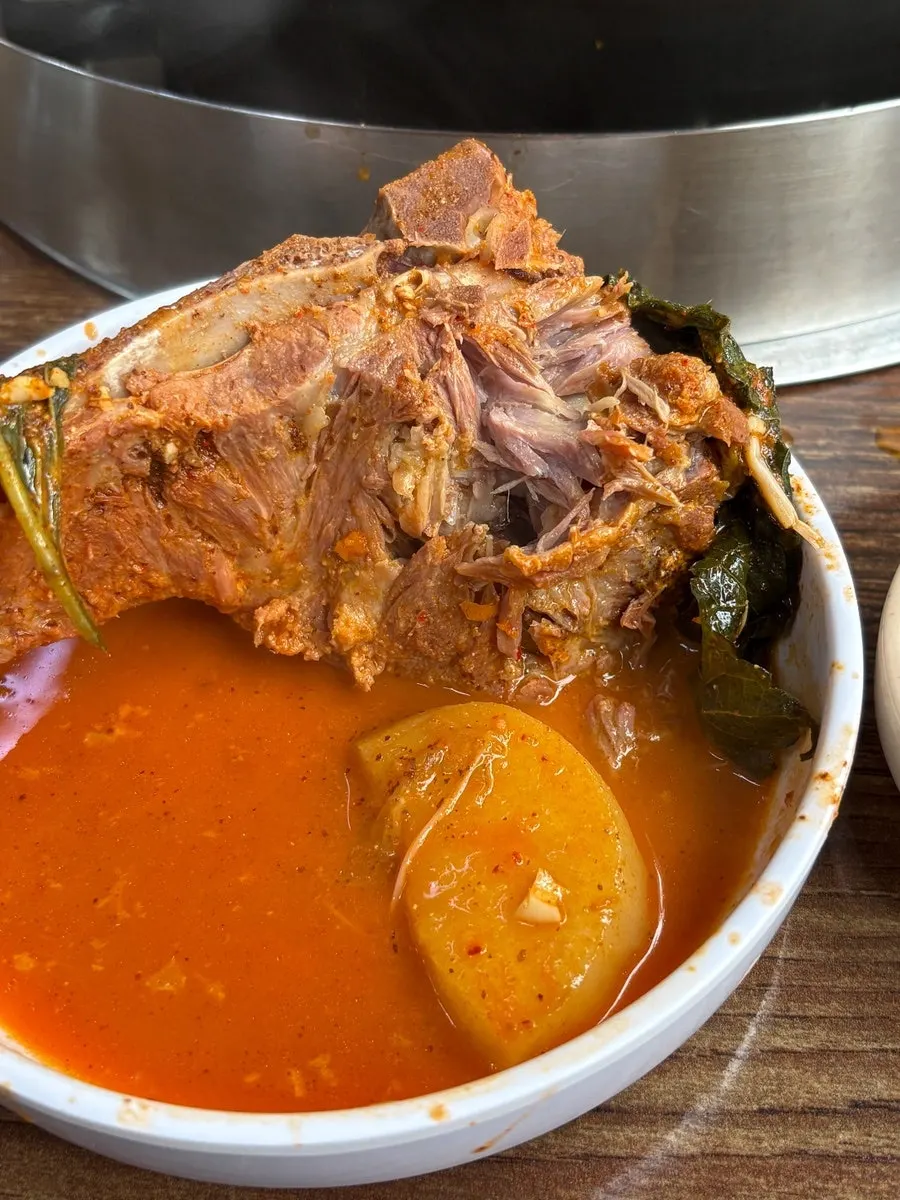 Deboned meat dipped into the seasoned broth