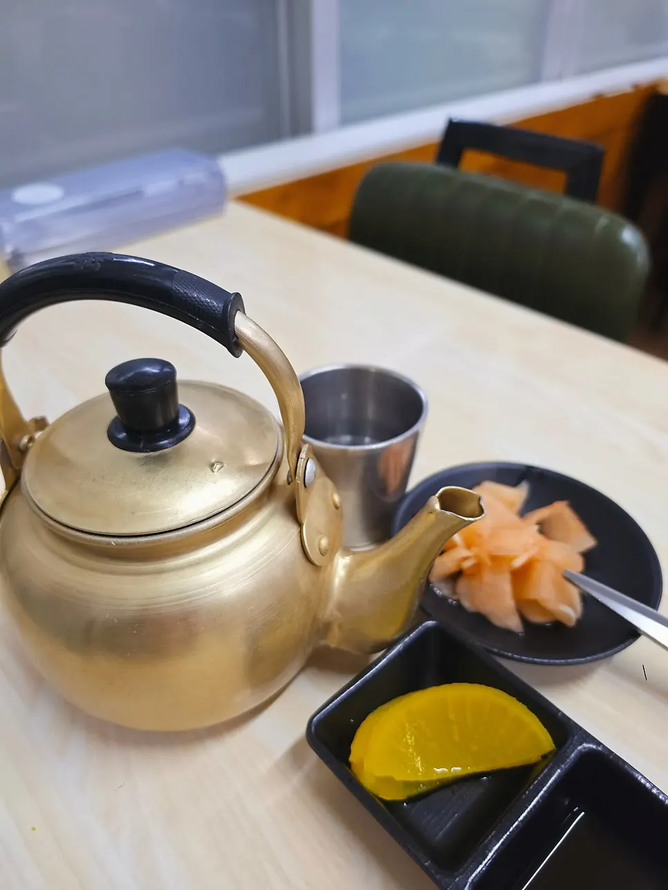 Hot broth in a kettle with pickled radish and seasoned radish
