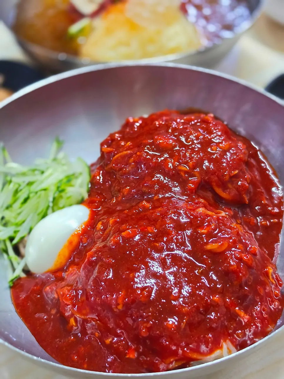 Large bibim milmyeon covered in red sauce
