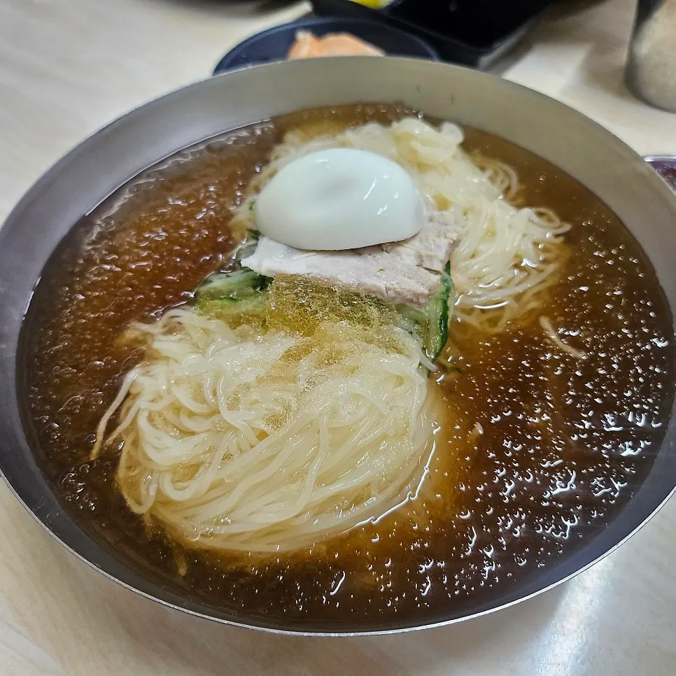 Water milmyeon topped with cucumber and meat garnish