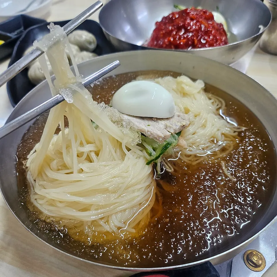 Thin milmyeon noodles lifted with chopsticks