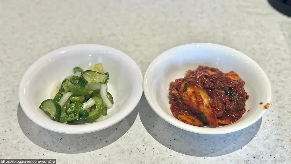 Basic side dishes at Songa Kalguksu: pickled cucumber and kimchi