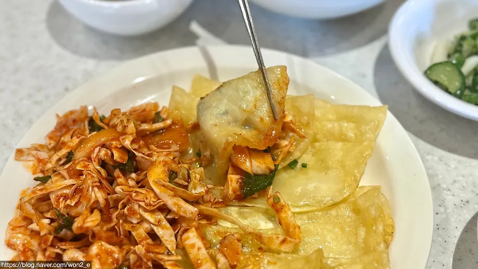 Picking up a piece of bibim-mandu