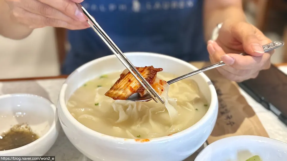 Hand-cut kalguksu noodles lifted with chopsticks