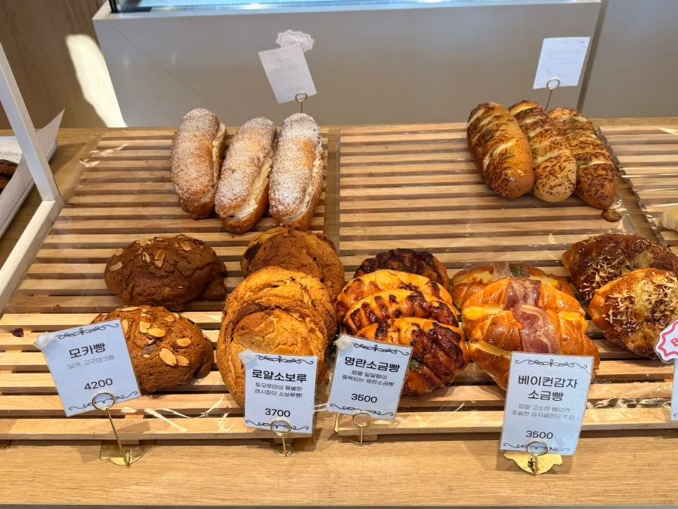 Full view of the display case with meal breads and desserts together