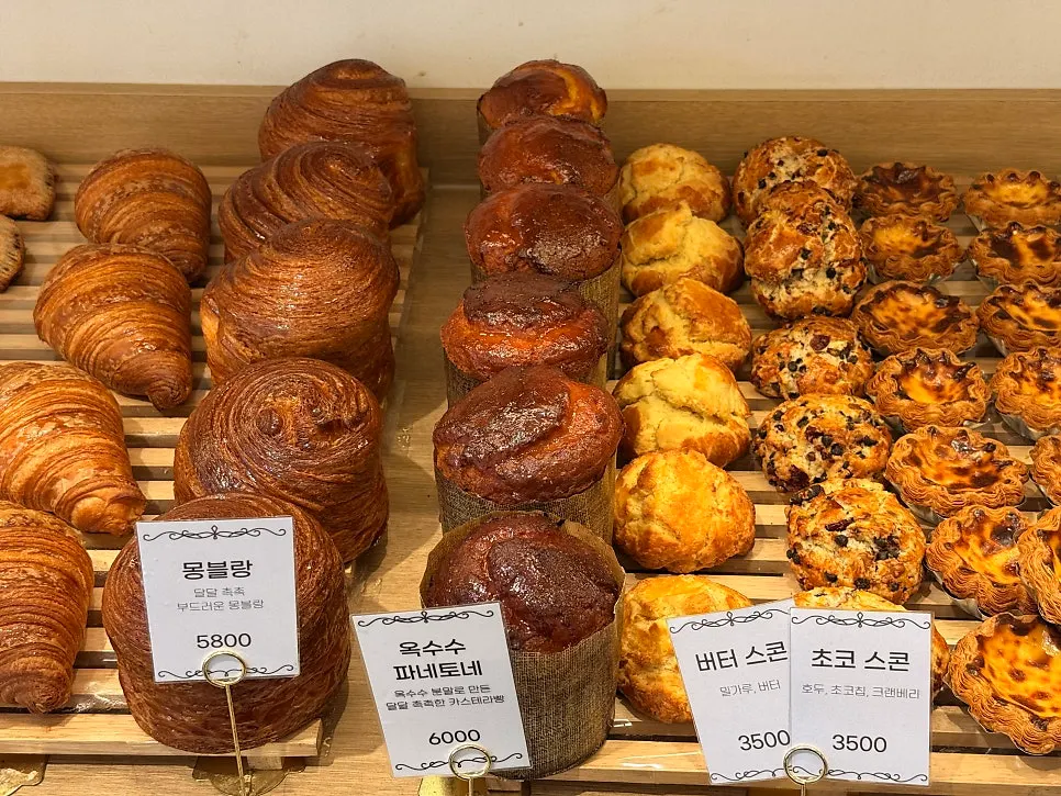 Various breads arranged on the bakery display shelf
