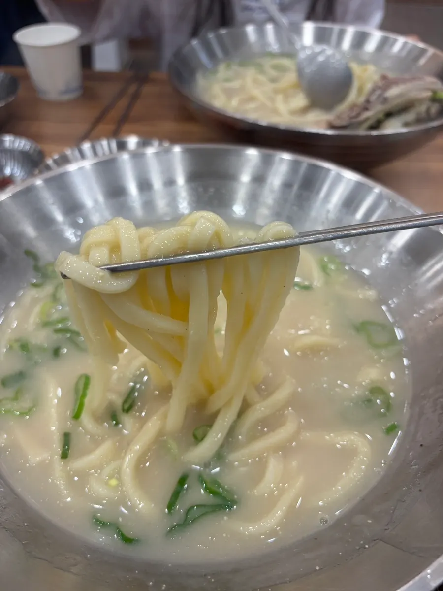 Chicken kalguksu topped with perilla seed powder