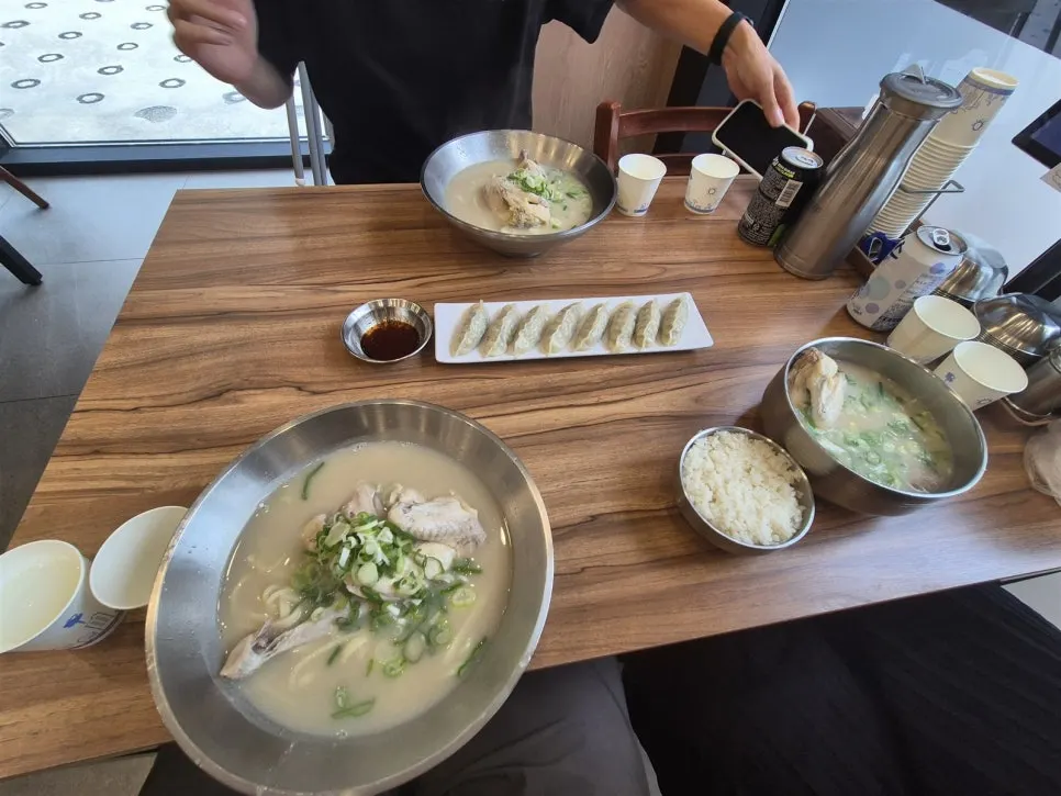 Table set with dak kalguksu, dak gomtang, and chewy mandu together