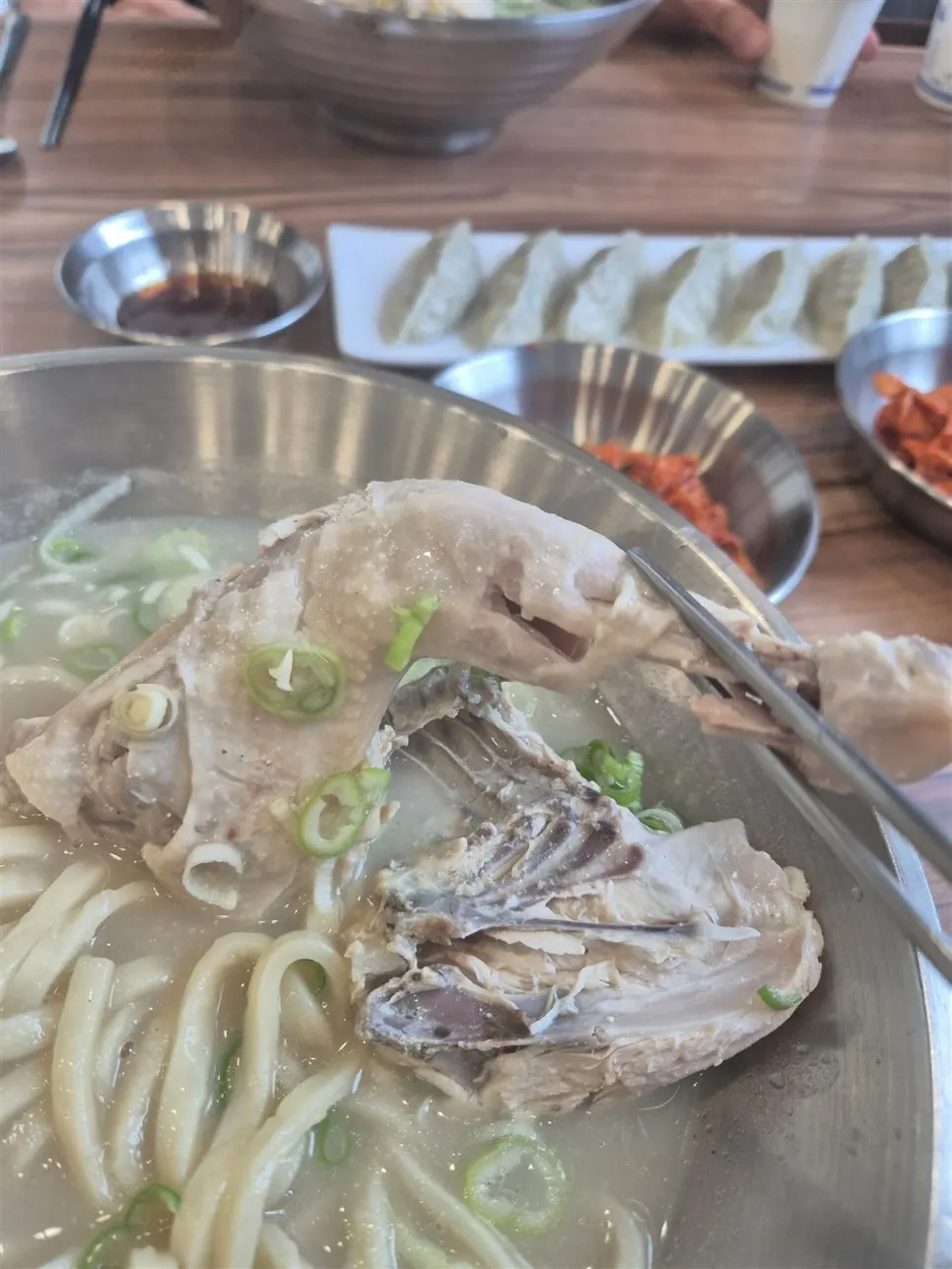 Milky chicken broth with large pieces of chicken