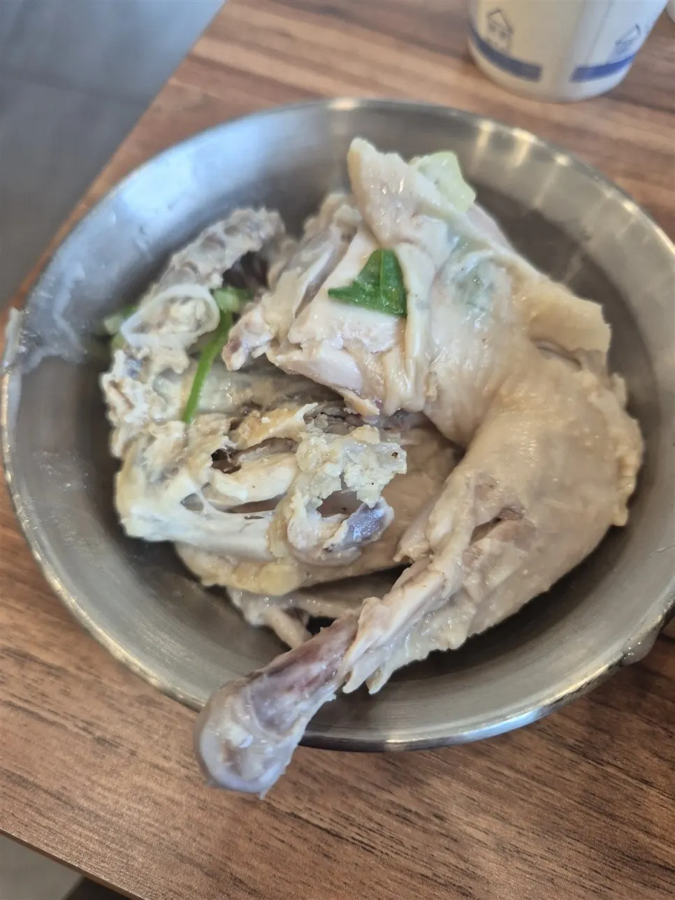 Half a chicken fished out of the broth and placed in a separate bowl