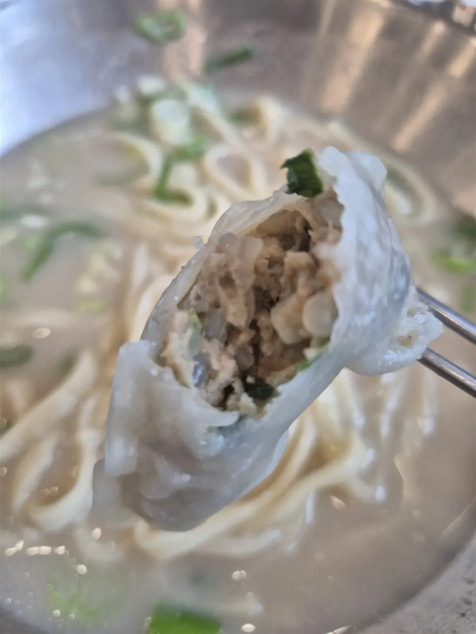 Chewy mandu cut in half showing the filling inside