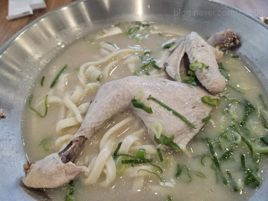 A whole half chicken sitting in the broth