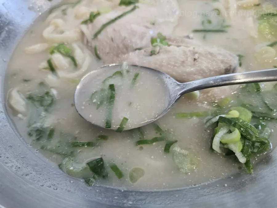 A bite combining chicken and kimchi