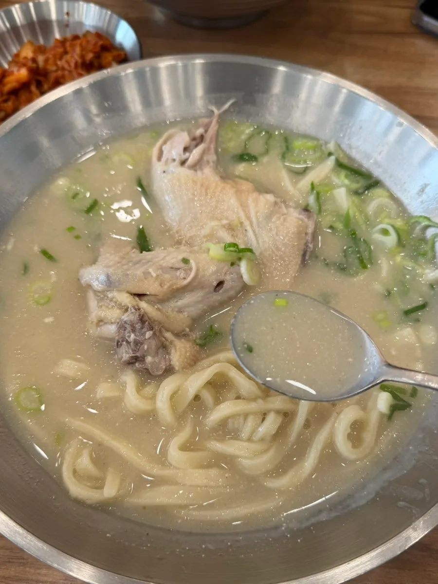 Meaty chicken pieces lifted out of the soup