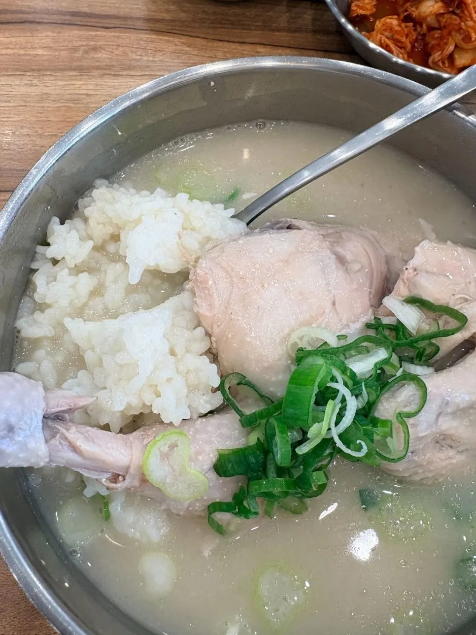 A spoonful of chicken gomtang rice soaked in broth