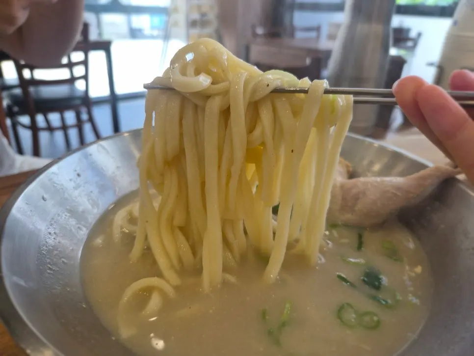 Chicken kalguksu with half a chicken