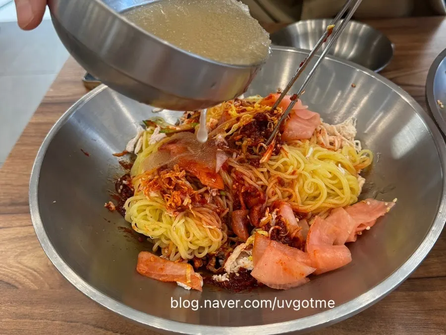 Chogye bibim guksu mixed with the icy broth poured in